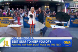 A still of a video of a Good Morning America segment where two women are discussing the best gear to keep you dry, holding a Repel Umbrella.