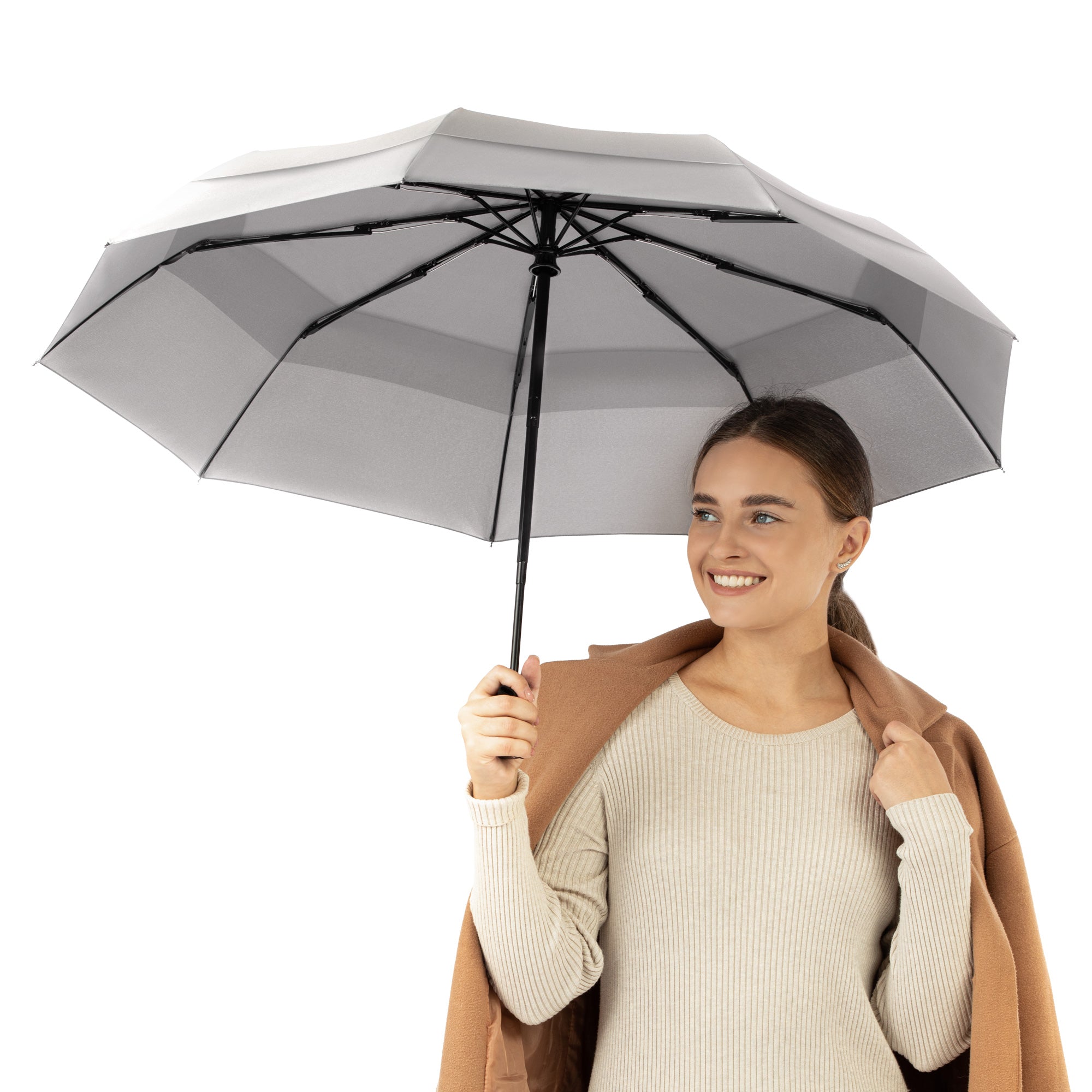 A woman holding the gray travel compact umbrella that is windproof and best selling from Repel Umbrella