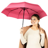 A woman holding the pink travel compact umbrella that is windproof and best selling from Repel Umbrella