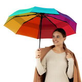 A woman holding the rainbow travel compact umbrella that is windproof and best selling from Repel Umbrella