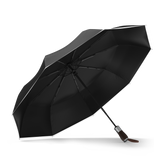 The Black, Premium Best-Selling Windproof Compact Travel Umbrella is pictured on it's own, open and leaning to the left.