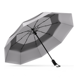 The GreyTop Best-Selling Windproof Compact Travel Umbrella is pictured on it's own, open and leaning to the left. 